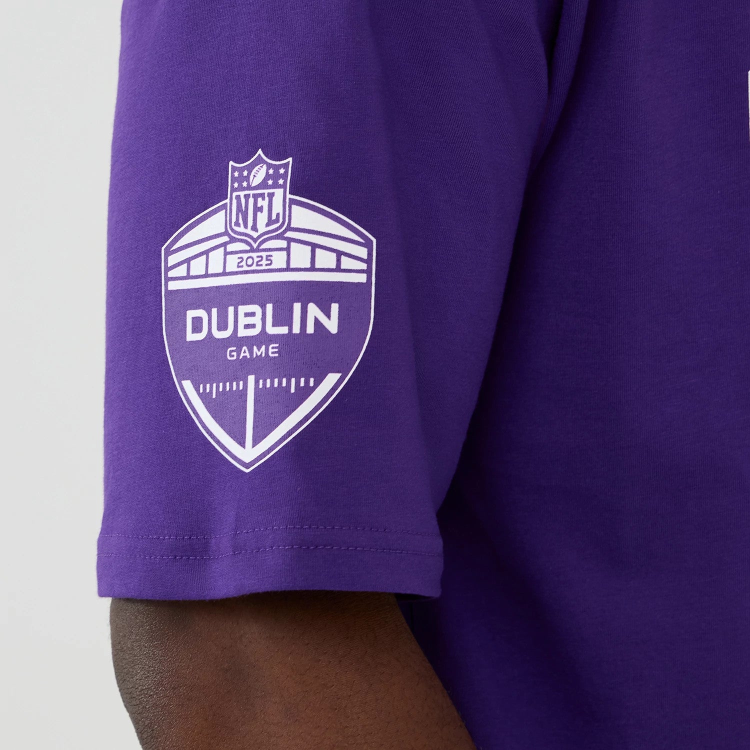 The Male model is wearing Minnesota Vikings NFL International Series Games 2025 Purple Oversized T-Shirt 4