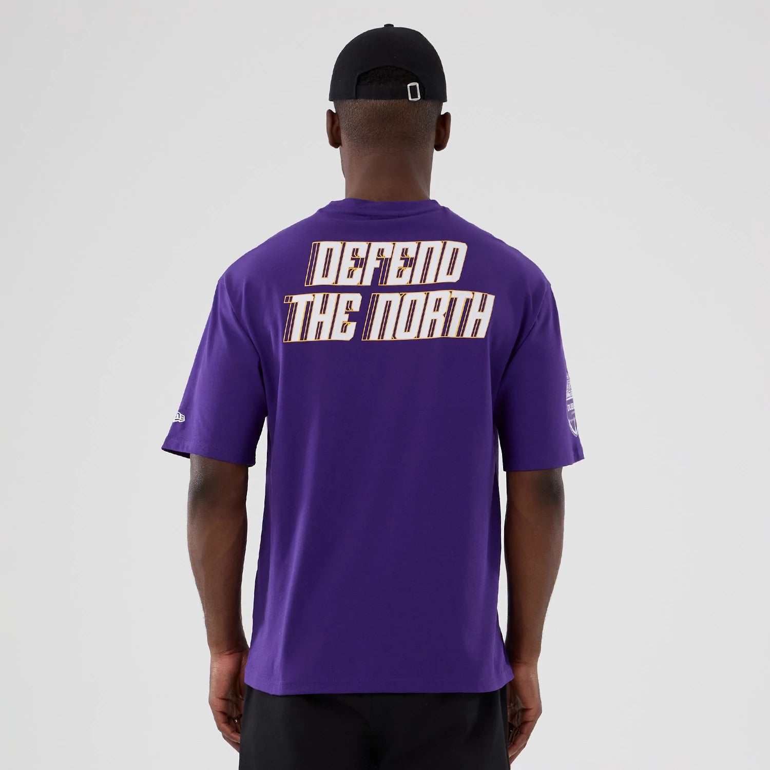 The Male model is wearing Minnesota Vikings NFL International Series Games 2025 Purple Oversized T-Shirt 2