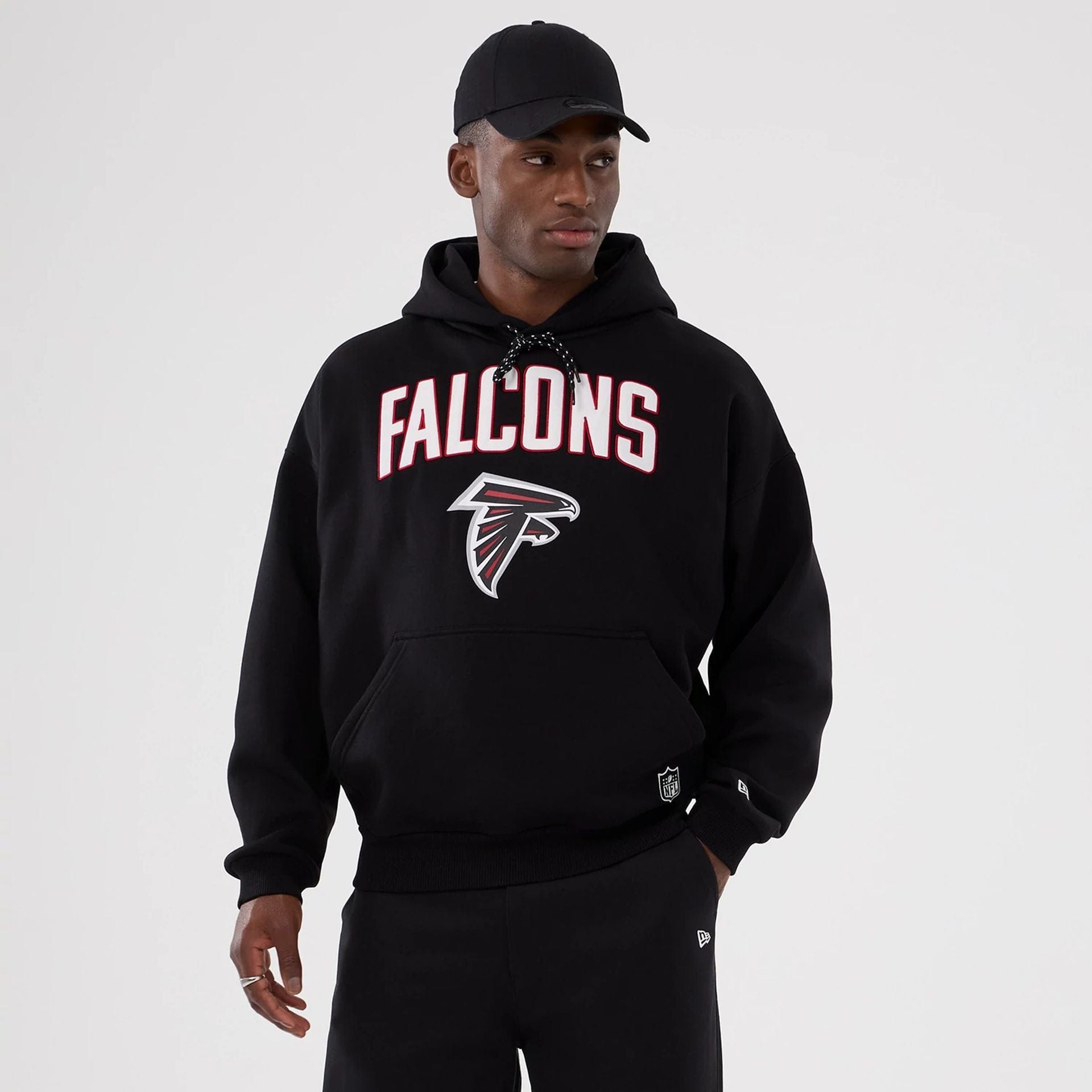 The Male model is wearing Atlanta Falcons NFL International Series Games 2025 Black Premium Pullover Hoodie 1