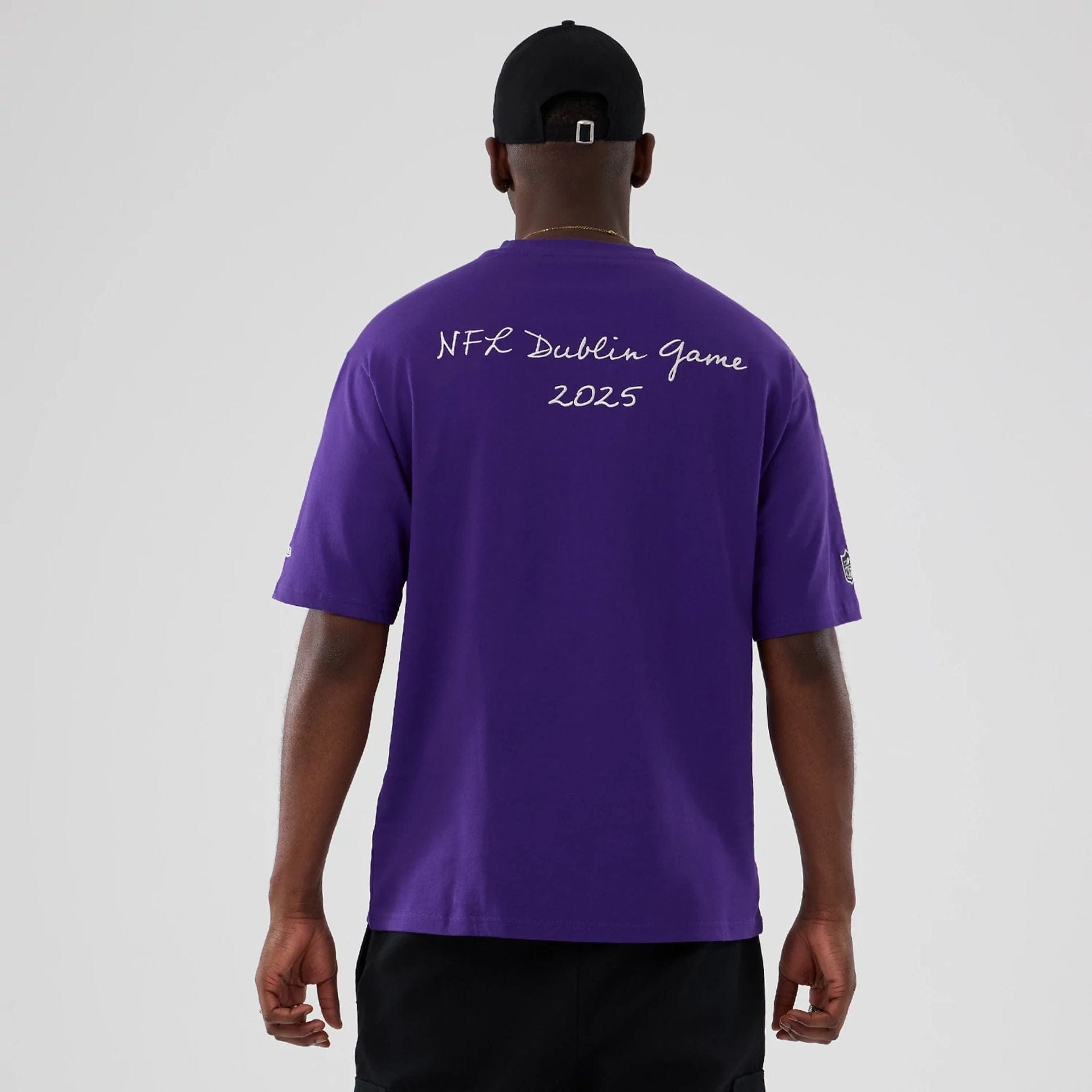 The Male model is wearing Minnesota Vikings NFL International Series Games 2025 Purple Premium T-Shirt 2