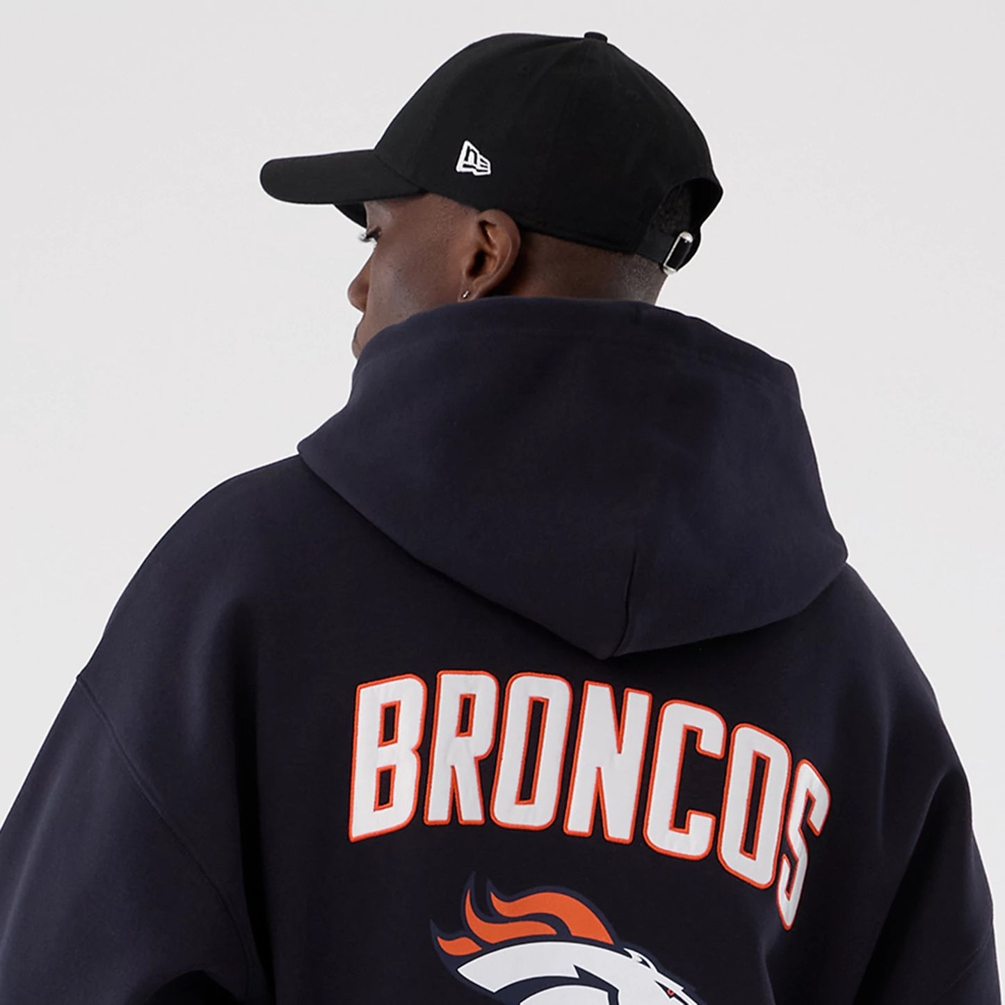 The Male model is wearing Denver Broncos NFL International Series Games 2025 Navy Premium Pullover Hoodie 7