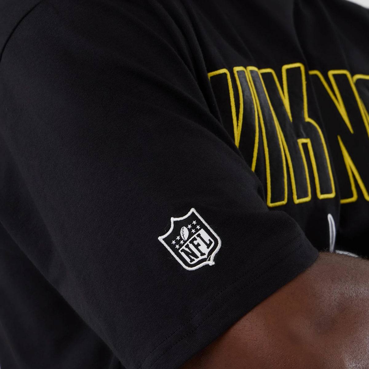 New Era Minnesota Vikings NFL International Series Games 2025 Black Premium T-Shirt, side view showing a white embroidered NFL shield logo on the sleeve and yellow VIKINGS lettering partially across the chest.