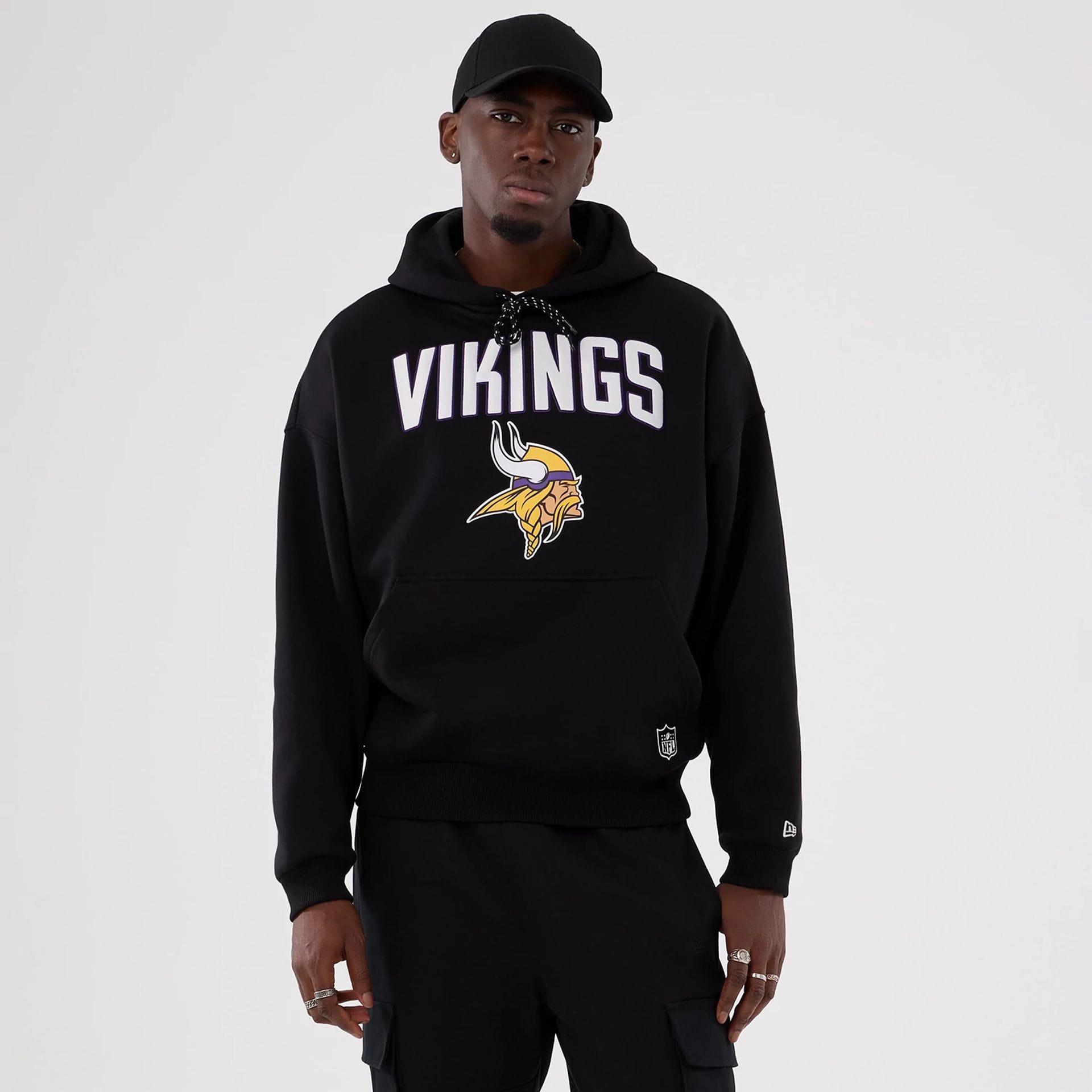 The Male model is wearing Minnesota Vikings NFL International Series Games 2025 Black Premium Pullover Hoodie 1
