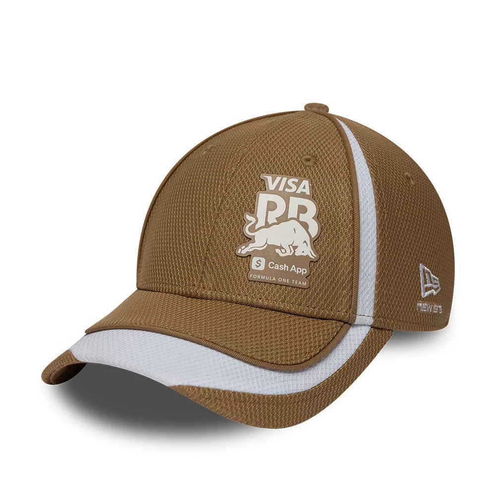 Visa Cash App Racing Bulls F1 Race Special Dark Beige New Era 9FORTY Adjustable Cap, three-quarter view showing the beige RB logo with bull image on the front panel, white striped visor, and embroidered New Era flag logo on the left side.
