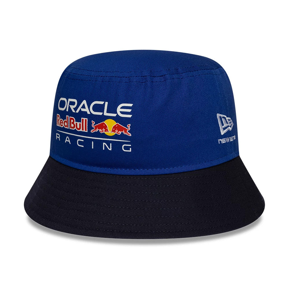 New Era Red Bull Racing Youth Essential Dark Blue Bucket Hat, front view showing the Oracle Red Bull Racing logo in white, red, and yellow on the blue crown, with a black visor and the embroidered New Era flag logo on the side.
