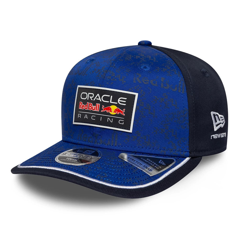 Red Bull Racing Youth Team Dark Blue New Era 9SEVENTY Stretch Snap Adjustable Cap, three-quarter view showing the raised Oracle Red Bull Racing logo on the front panel, silver size sticker on the blue visor and New Era flag logo on the left side.