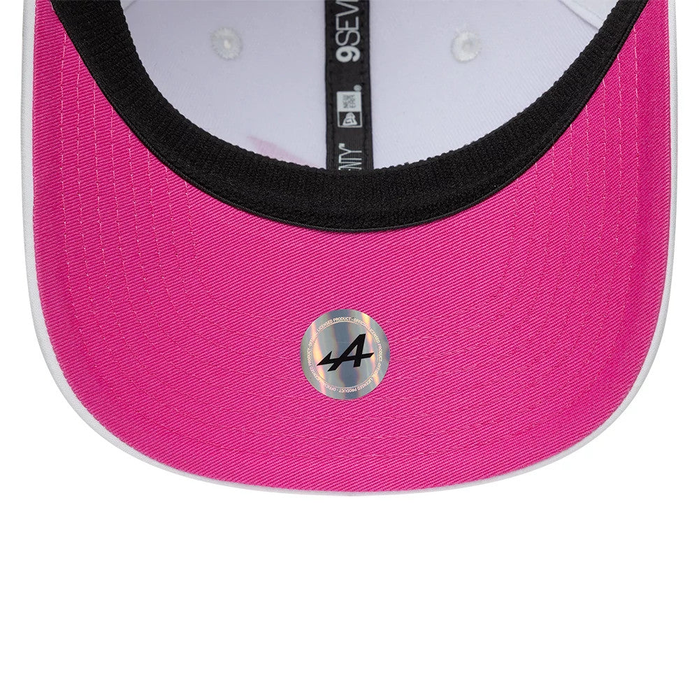 Alpine Racing Miami Race Special White New Era 9SEVENTY Stretch Snap Adjustable Cap, inside view showing the bright pink undervisor with a circular logo sticker, black sweatband, and white taping with size label.