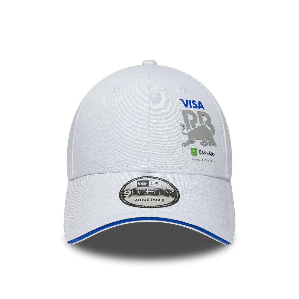 Visa Cash App Racing Bulls Essential White New Era 9FORTY Adjustable Cap, front view showing the embroidered Visa and Red Bull Racing logos on the front panel, with a dark 9FORTY size sticker and royal blue undervisor edge on the curved white visor.