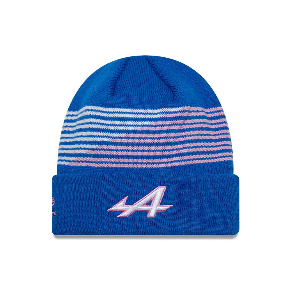 New Era Alpine Racing Team Blue Cuff Knit Beanie Hat, front view showing the pink and white striped pattern on the upper section and the embroidered Alpine logo in pink and white on the blue cuff.