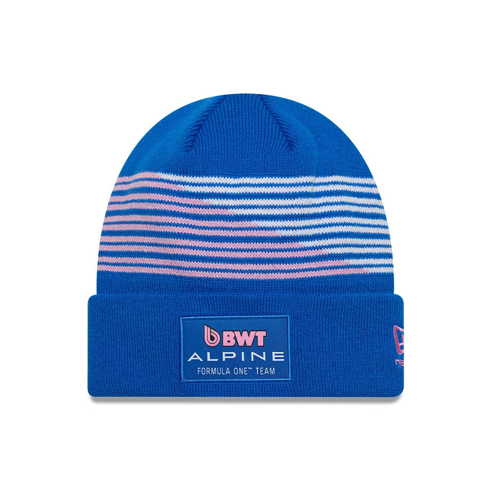 New Era Alpine Racing Team Blue Cuff Knit Beanie Hat, front view showing a blue and pink striped design on the crown, with a BWT Alpine Formula One Team patch on the blue cuff and pink New Era logo on the side.