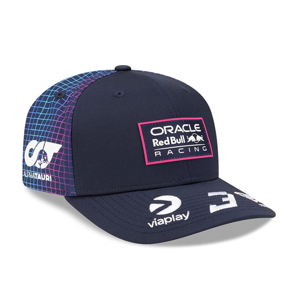 Red Bull Racing Miami Race Special Max Verstappen Navy New Era 9SEVENTY Stretch Snap Adjustable Cap, three-quarter view showing the Red Bull Racing logo with a pink border on the front panel, a colourful grid pattern on the side.