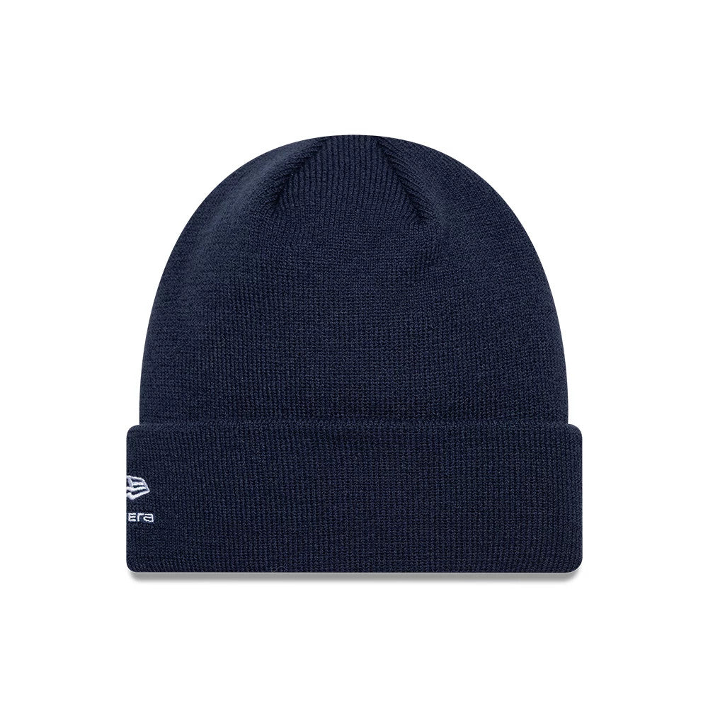 New Era Alpine Racing Essential Dark Blue Cuff Knit Beanie Hat, front view showing the turned-up cuff with the white embroidered New Era flag logo on the left side, set against a deep blue knit fabric.