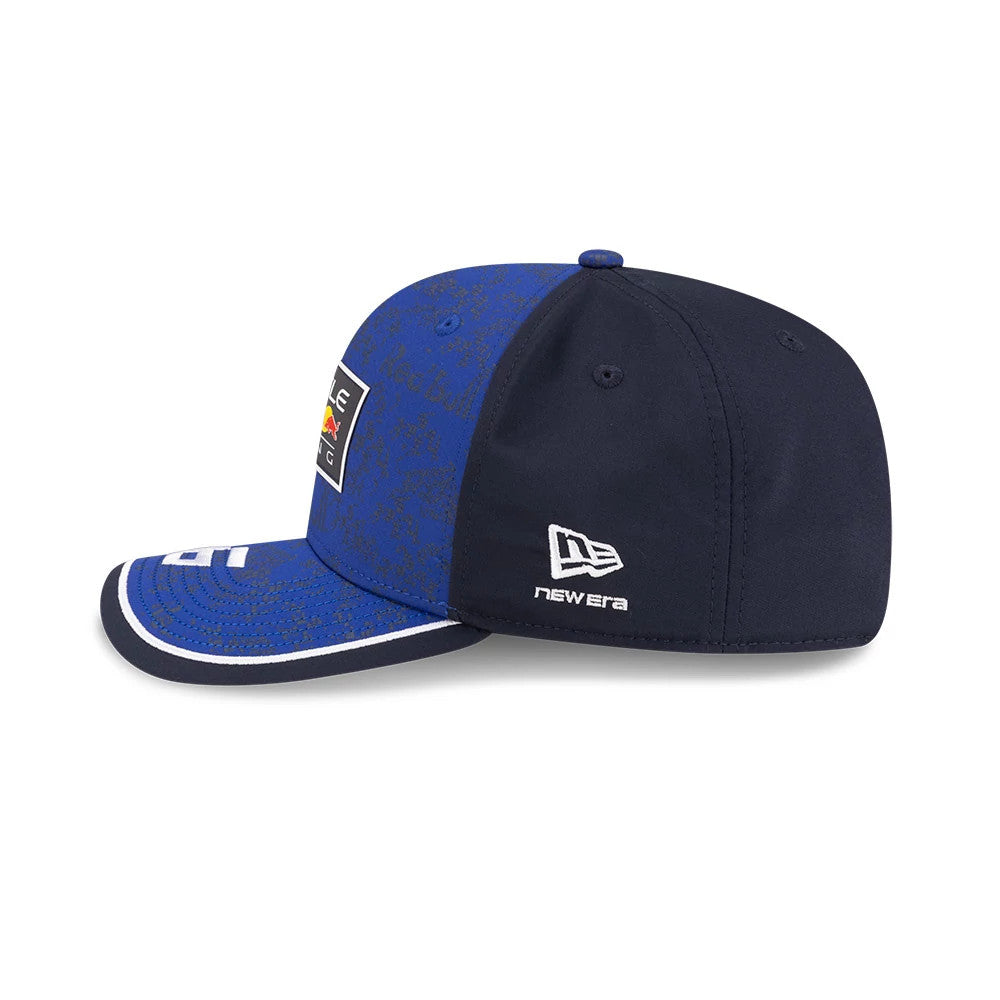 Red Bull Racing Isack Hadjar Dark Blue New Era 9SEVENTY Stretch Snap Adjustable Cap, side view showing the white embroidered New Era flag logo on the left side, with a dark blue curved visor and top button.