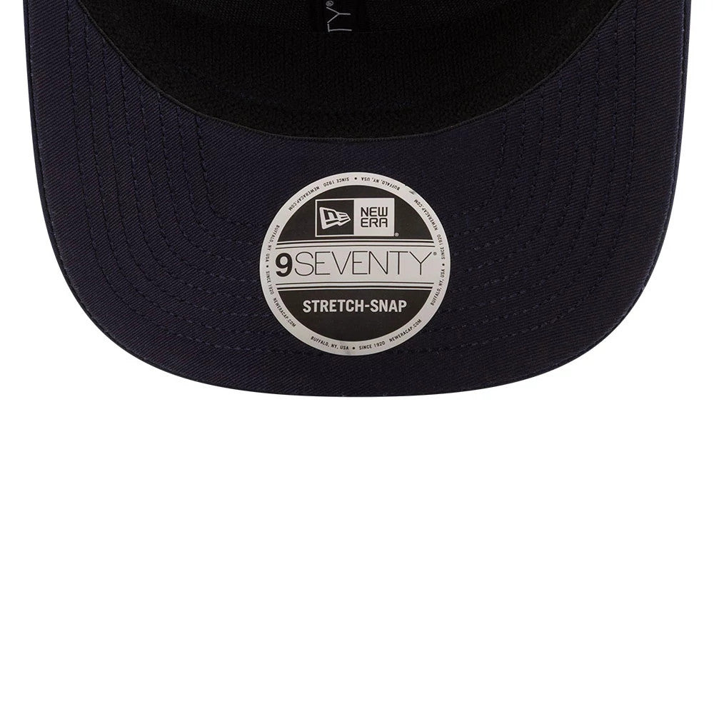 Red Bull Racing Isack Hadjar Dark Blue New Era 9SEVENTY Stretch Snap Adjustable Cap, underside view showing the black undervisor and large 9SEVENTY size sticker at the centre of the dark blue visor.