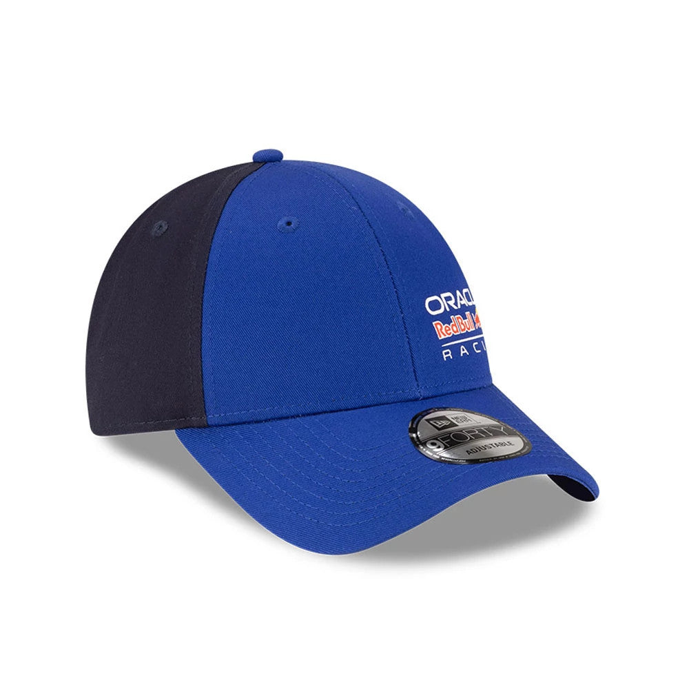 Red Bull Racing Essential Dark Blue New Era 9FORTY Adjustable Cap, three-quarter view showing the white and red embroidered Oracle Red Bull Racing logo on the front panel and the 9FORTY size sticker on the curved dark blue visor.