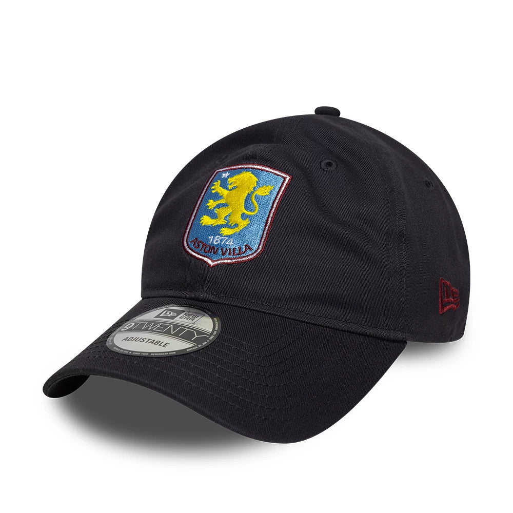 Aston Villa FC Core Navy New Era 9TWENTY Cap, front view showing the raised embroidered Aston Villa lion crest in yellow and blue centred on the unstructured navy crown, with a 9TWENTY size sticker on the curved visor.