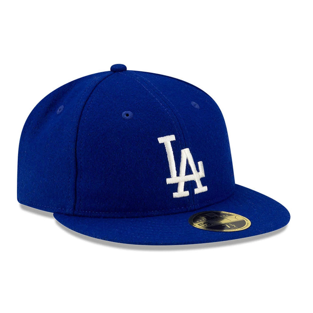 LA Dodgers FOG X MLB Dark Blue Retro Crown New Era 59FIFTY Fitted Cap, three-quarter view showing raised white LA embroidery on the front panel, flat blue visor and a gold 59FIFTY size sticker on the visor.