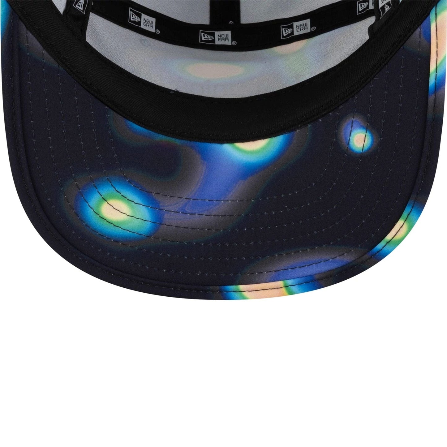 Hermanos Koumori x New Era Navy Camper Cap, inside view showing multicoloured abstract patterns on the visor and black New Era taping along the interior seam with light grey sweatband.