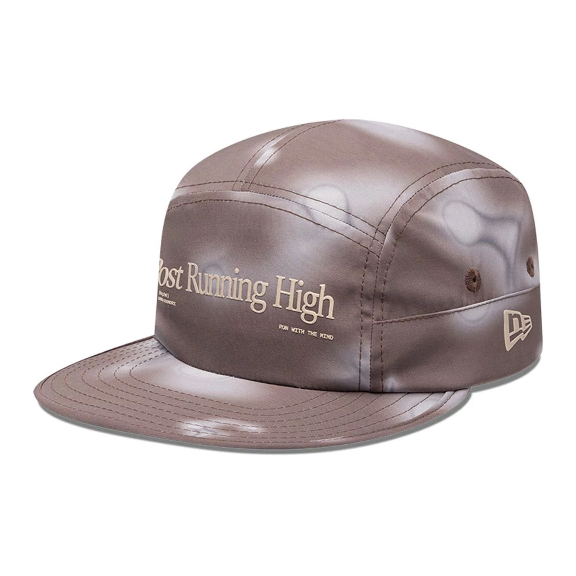 Pictured is this Hermanos Koumori x New Era Camper cap in dark brown. 1