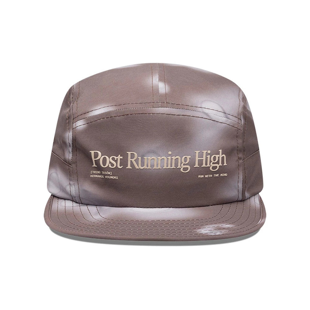 Hermanos Koumori x New Era Dark Brown Camper Cap, front view showing cream embroidered Post Running High text on the structured dark brown crown with a matching flat visor and distinct panel seams.