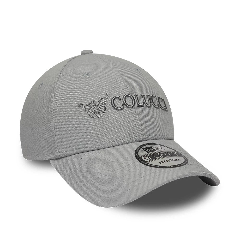 Colucci X New Era Grey 9FORTY Adjustable Cap, three-quarter view showing the raised embroidery of the Colucci logo on the structured grey crown, with a curved visor and a 9FORTY size sticker on top.