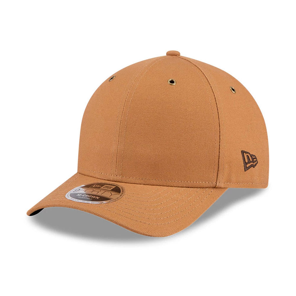 New Era Beige 9FORTY M-Crown Adjustable Cap, three-quarter view showing the black embroidered New Era flag logo on the left side, with a curved visor featuring a 9FORTY size sticker and matching beige top button.