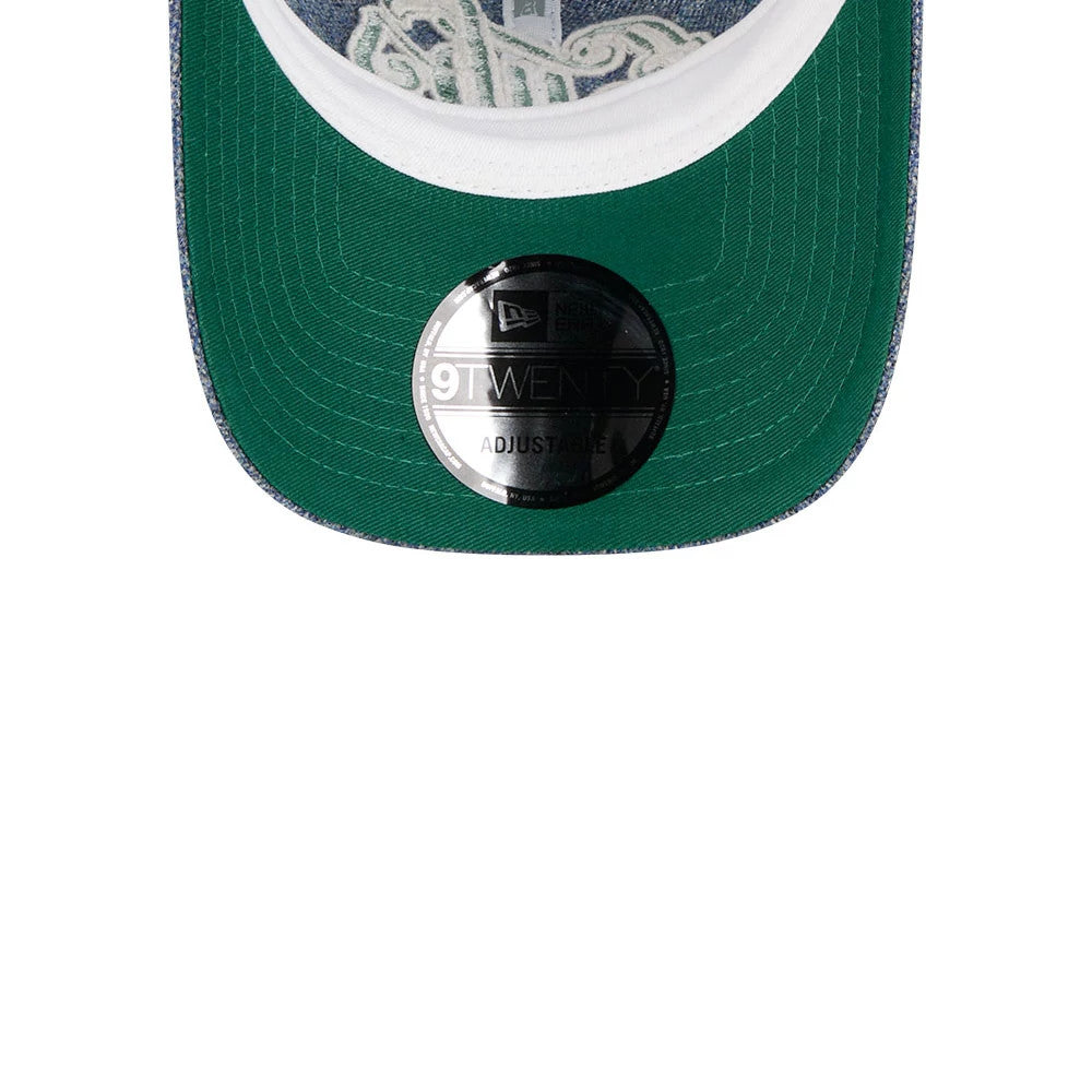 Chicago Cubs MLB X Moon Blue New Era 9TWENTY Adjustable Cap, inside view showing the dark green undervisor with a 9TWENTY size sticker, white interior band, and decorative stitching through the fabric.