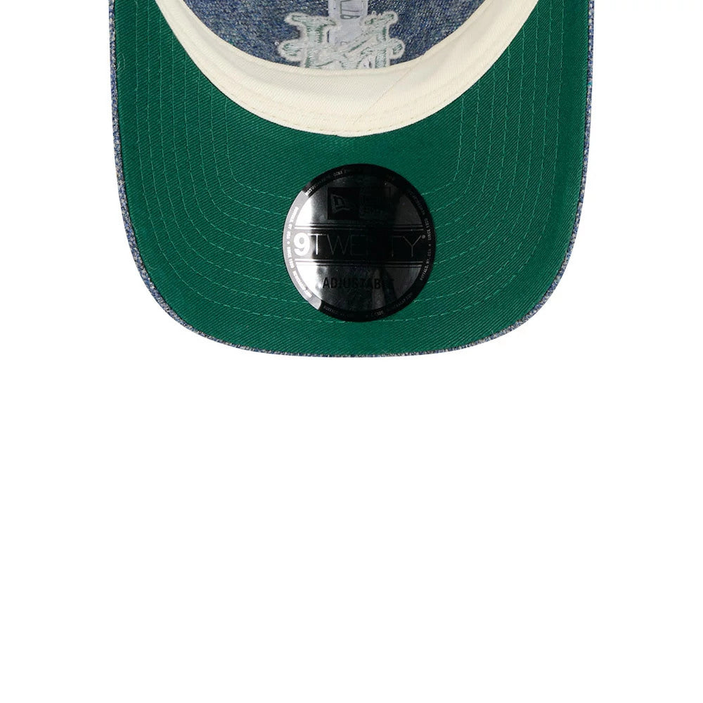 New York Mets MLB X Moon Blue New Era 9TWENTY Adjustable Cap, inside view showing a green undervisor with a 9TWENTY size sticker, white taping surrounding the top panels, and an embroidered logo detail through the visor.