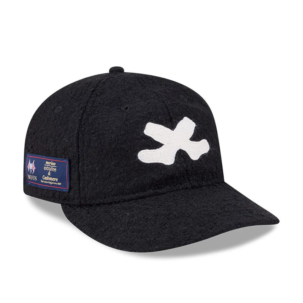 Chicago White Sox MLB X Moon Navy Retro Crown New Era 9FIFTY Adjustable Cap, three-quarter view showing a large white embroidered X on the front panel and a Moon merino label on the left side of the soft, dark navy crown.