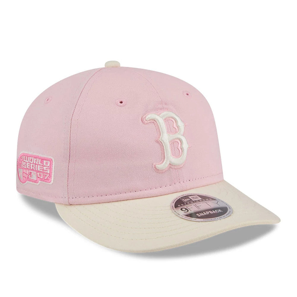 Boston Red Sox MLB Washed Tie Dye Pastel Pink New Era 9FIFTY Snapback Adjustable Cap, three-quarter view showing a white embroidered B on the front panel, pink World Series 2007 side patch, and a cream-coloured visor with a 9FIFTY size sticker.