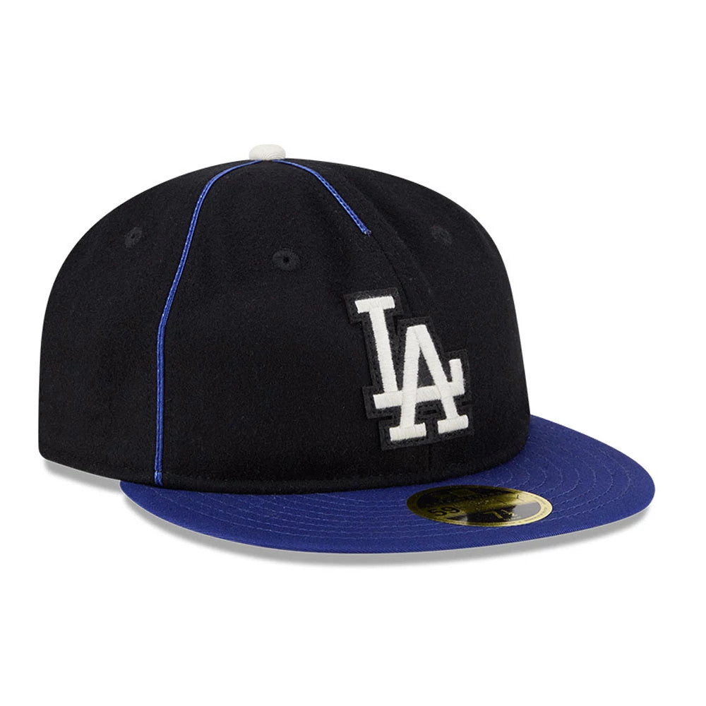 LA Dodgers MLB Felt Logo Dark Blue Retro Crown New Era 59FIFTY Fitted Cap, three-quarter view with raised white LA logo on front panel, contrasting blue flat visor, and a gold 59FIFTY size sticker.