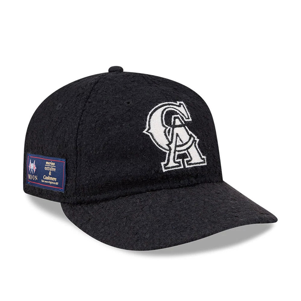 LA Angels MLB X Moon Navy Retro Crown New Era 9FIFTY Adjustable Cap, front view showing the prominent white embroidered CA logo on the front panel, with a patch on the left side and the textured navy fabric of the visor.