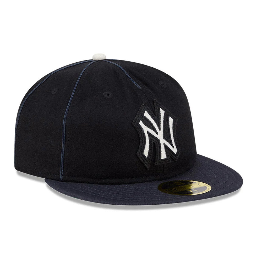 New York Yankees MLB Felt Logo Navy Retro Crown New Era 59FIFTY Fitted Cap, three-quarter view showing the white and black raised embroidered Yankees logo on the front panel, a navy flat visor, and a gold 59FIFTY size sticker on the visor.