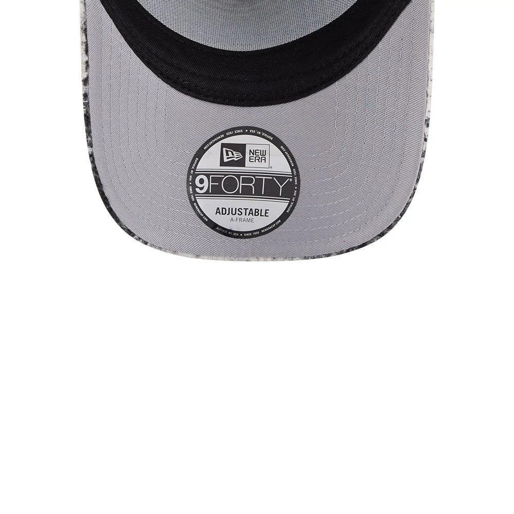 New Era White & Black Plaid 9FORTY A-Frame Trucker Adjustable Cap, inside view with grey undervisor featuring a 9FORTY size sticker, black sweatband encircling the structured fit, and interior stitching lines enhancing durability.