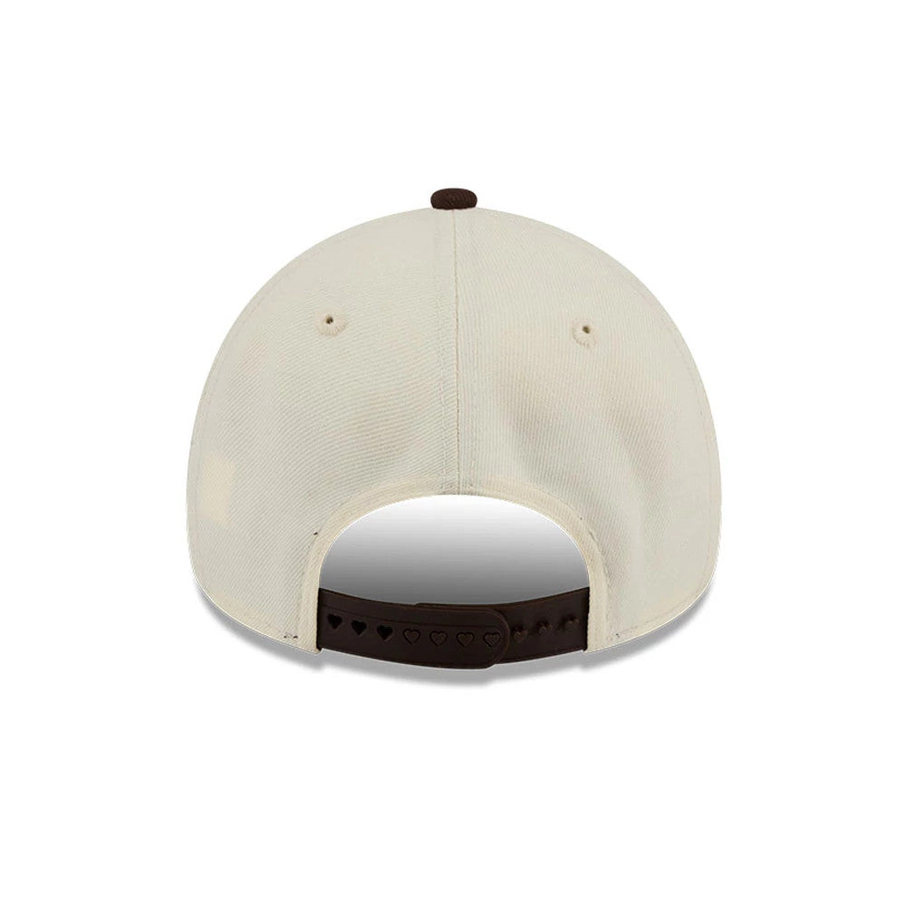 Athletics MLB City Script Cream New Era 9FORTY A-Frame Adjustable Cap, rear view showing the brown adjustable strap with heart-shaped holes, cream-coloured structured crown with matching eyelets, and a contrasting dark brown top button.