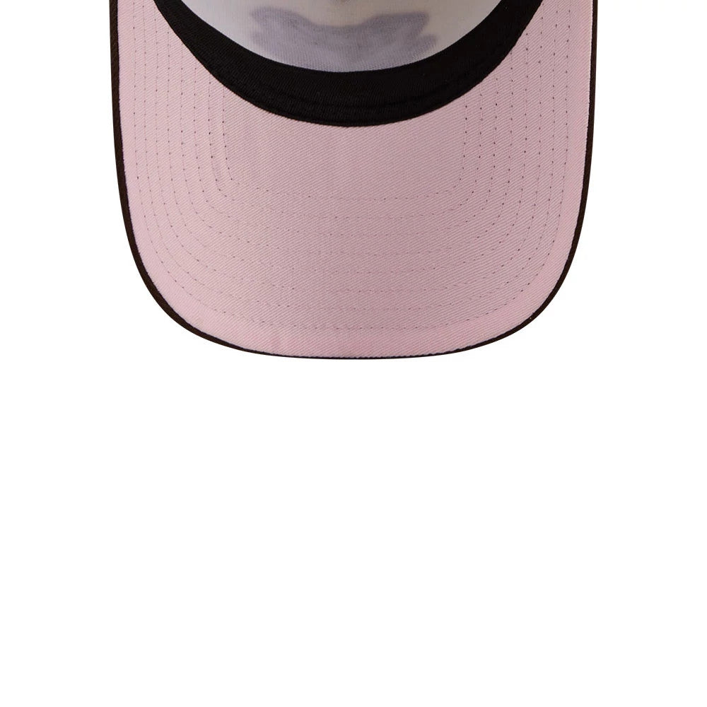 Athletics MLB City Script Cream New Era 9FORTY A-Frame Adjustable Cap, inside view showing the light pink undervisor with stitching details, a black inside rim, and a faint shadow pattern across the middle.