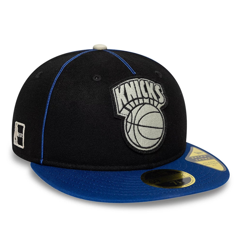 New York Knicks NBA Felt Logo Dark Blue Retro Crown New Era 59FIFTY Fitted Cap, three-quarter view showing the grey Knicks logo with raised embroidery on the front panel, a bright blue visor and a gold 59FIFTY size sticker.