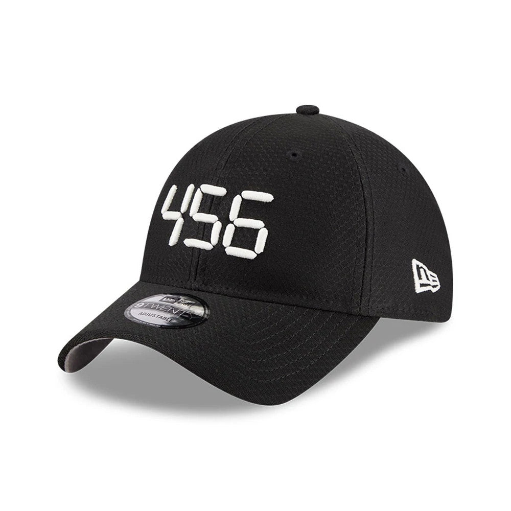 Netflix Squid Game 456 Black New Era 9TWENTY Adjustable Cap, three-quarter view showing the white embroidered 456 on the black front panels, a New Era flag logo on the left side, and a 9TWENTY size sticker on the black curved visor.