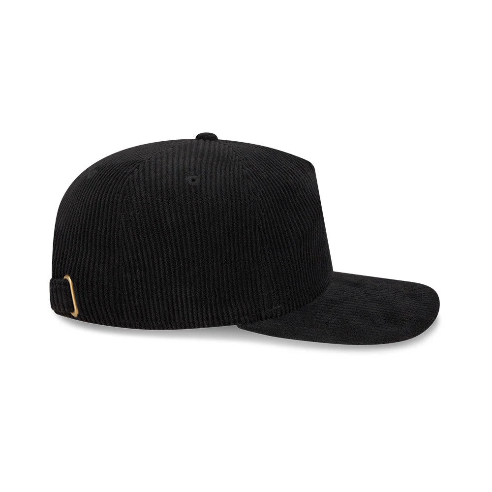 New Era Wide Cord Black 19TWENTY Adjustable Cap, side view showing a black wide corduroy texture across the unstructured crown and flat visor, with a golden buckle fastening on the adjustable strap at the back.