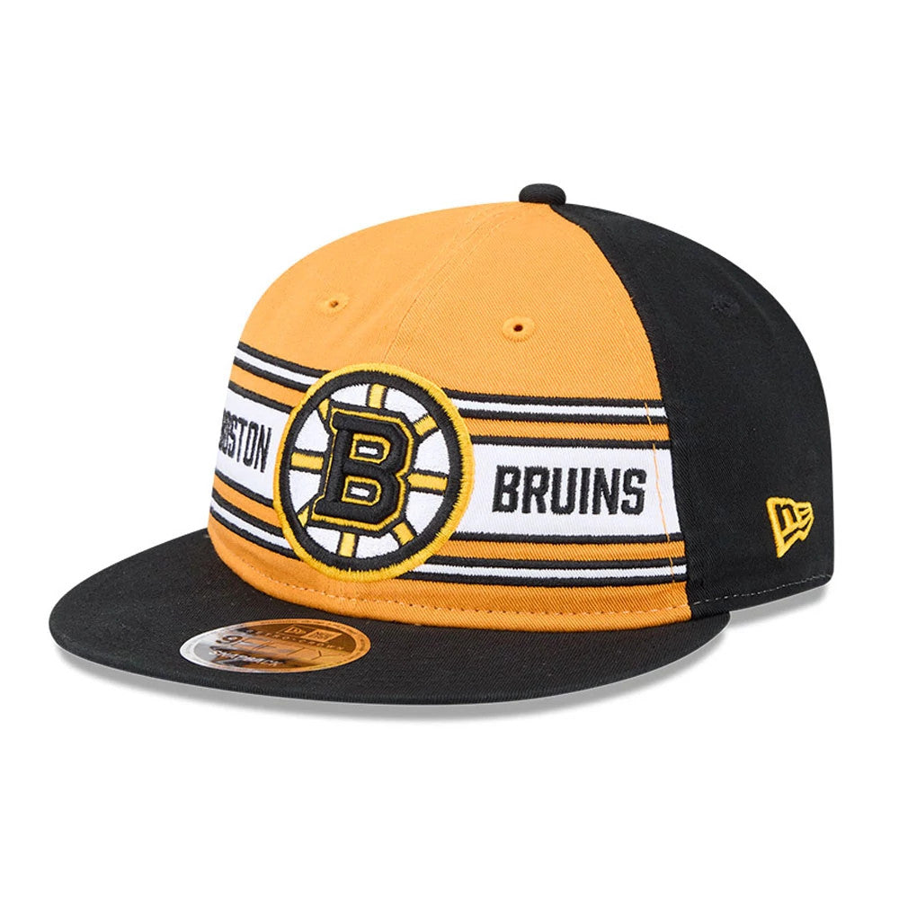 Bruins NHL Team Stripes Black Retro Crown New Era 9FIFTY Adjustable Cap, front view showing the embroidered team logo on the front panels with yellow and black stripes, black visor with a 9FIFTY size sticker, and New Era flag logo on the left side.