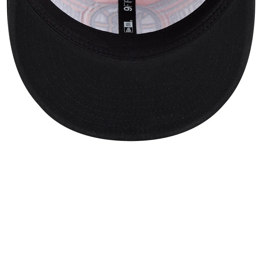Bruins NHL Team Stripes Black Retro Crown New Era 9FIFTY Adjustable Cap, inside view showing a black visor and woven taping with the 9FIFTY label at the centre, alongside a patterned design on the fabric lining the crown.