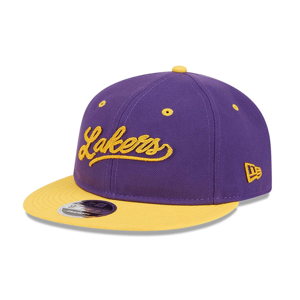 LA Lakers NBA Chainstitch Script Purple Retro Crown New Era 9FIFTY Adjustable Cap, three-quarter view showing the gold embroidered Lakers script logo on the front purple panels, a matching yellow flat visor, and New Era flag logo on the left side.