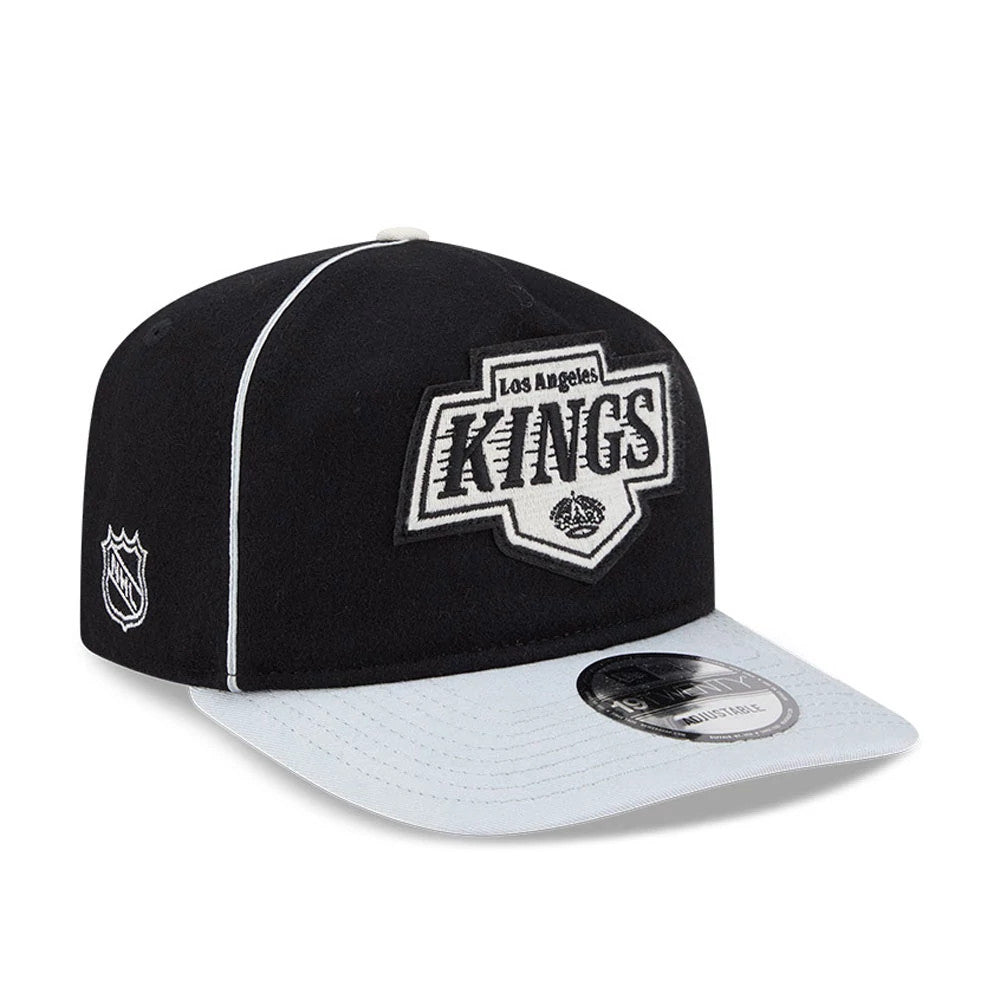 LA Kings NHL Felt Logo Black New Era 19TWENTY Adjustable Cap, front view showing a large black and white embroidered Kings logo on the front panel, a grey curved visor with a 19TWENTY size sticker, and an NHL logo on the right side.