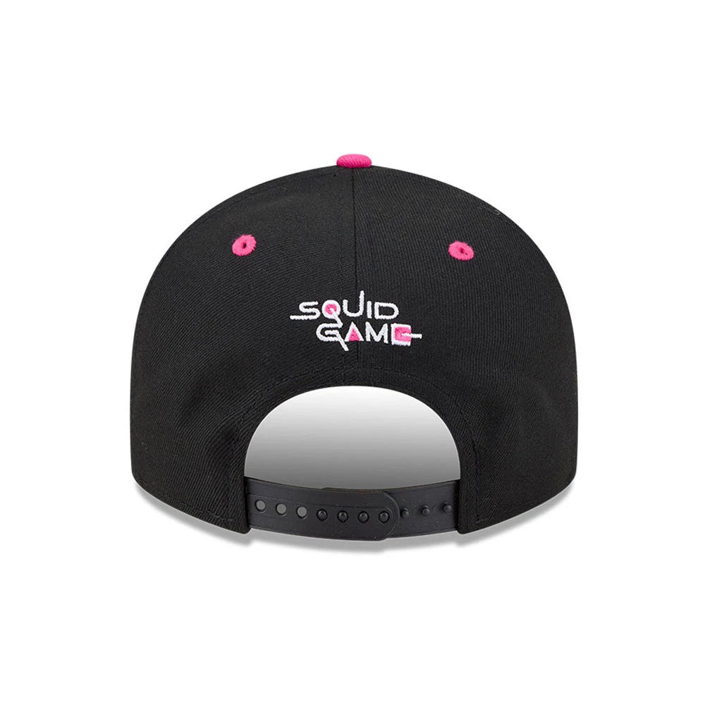 Netflix Squid Game Armed Guard Black New Era 9FIFTY Snapback Adjustable Cap, rear view showing the pink and white embroidered Squid Game logo at the centre back, with matching pink eyelets and top button on the black crown.