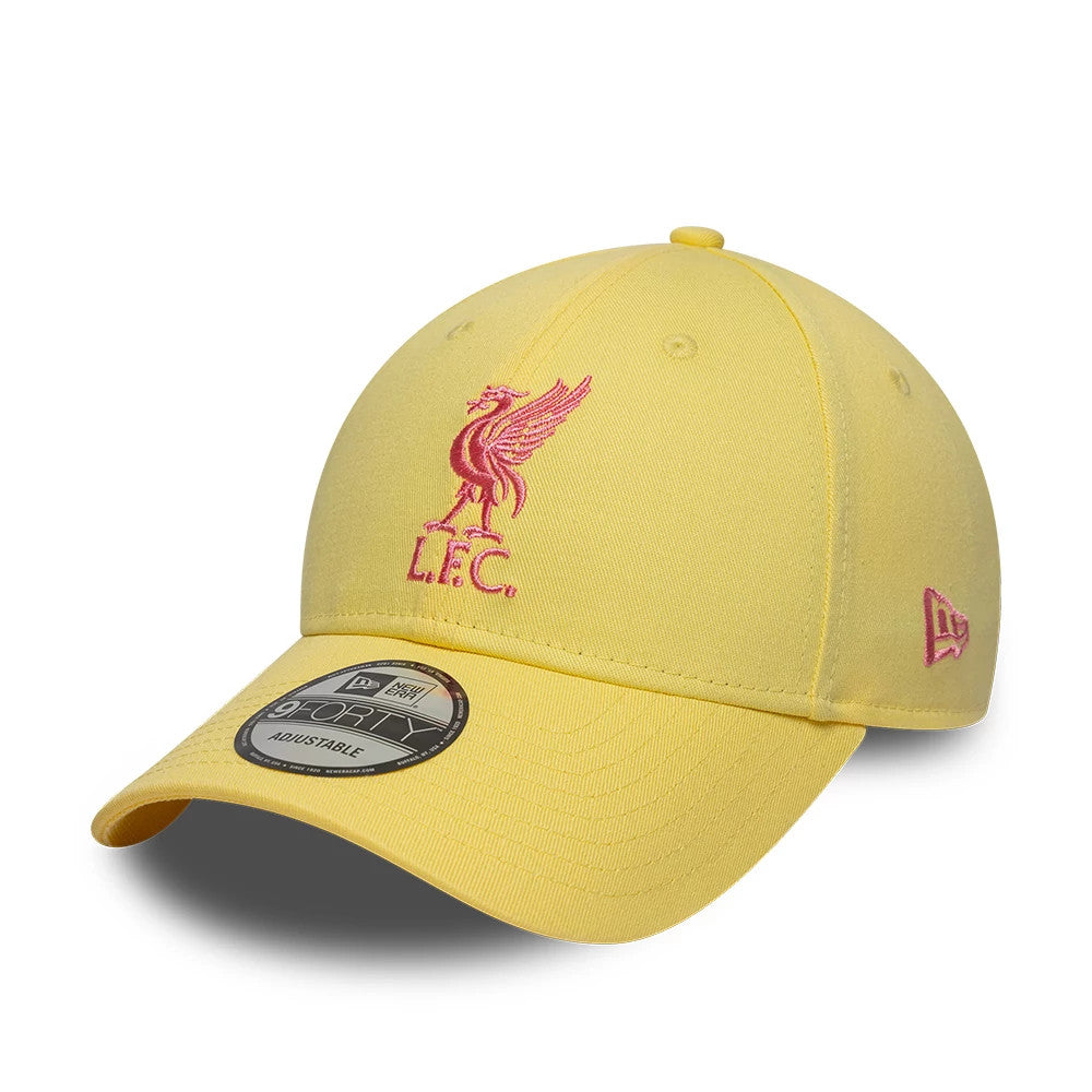 Liverpool FC Womens Pastel Yellow New Era 9FORTY Adjustable Cap, front view showing the pink embroidered L.F.C. logo on the structured crown, with a matching pink New Era flag logo on the left side and a 9FORTY size sticker on the curved visor.