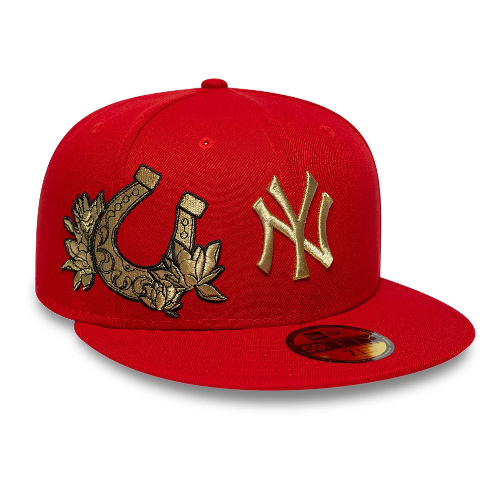 New York Yankees MLB Horseshoe Red New Era 59FIFTY Fitted Cap, three-quarter view showing the raised gold NY logo on the front panel, the decorative embroidered gold horseshoe and floral design on the side.