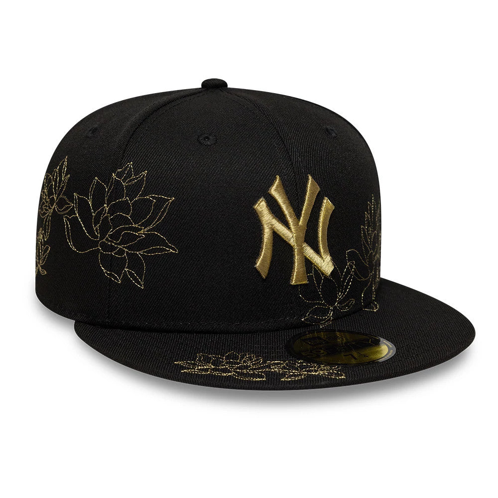 New York Yankees MLB Floral Black New Era 59FIFTY Fitted Cap, three-quarter view showing the gold raised embroidered NY logo on the black front panel, intricate gold floral embroidery on the side and visor, and gold 59FIFTY size sticker on the visor.