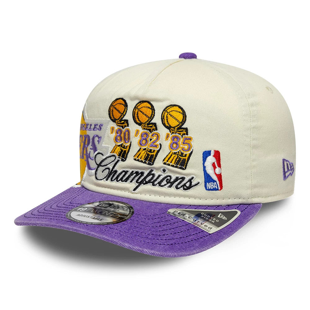LA Lakers NBA Hardwood Classic Cream New Era 19TWENTY Adjustable Cap, front and side view showing embroidered NBA championship trophies from '80, '82, '85 with Champions text, a purple embroidered New Era flag logo.
