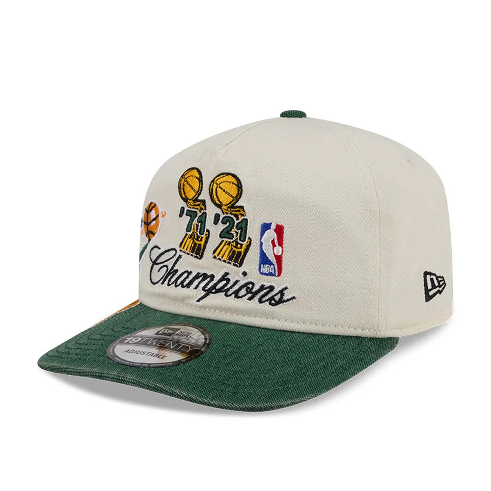 Milwaukee Bucks NBA Hardwood Classic Green New Era 19TWENTY Adjustable Cap, three-quarter view showing the detailed embroidered graphics of championship trophies and years '71 and '21 on the front panels, with a green visor and 19TWENTY size sticker.