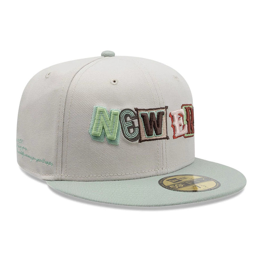 New Era DIY Note Light Beige 59FIFTY Fitted Cap, front view showing multicoloured raised embroidery of stacked letters spelling 'NEW ERA' on the front panel, with a light green visor and a gold 59FIFTY size sticker on the visor.